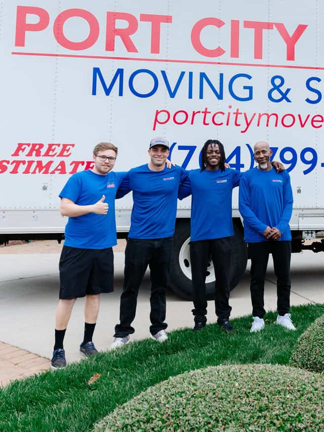 Port City Movers crew standing in front of company moving truck in North Carolina.