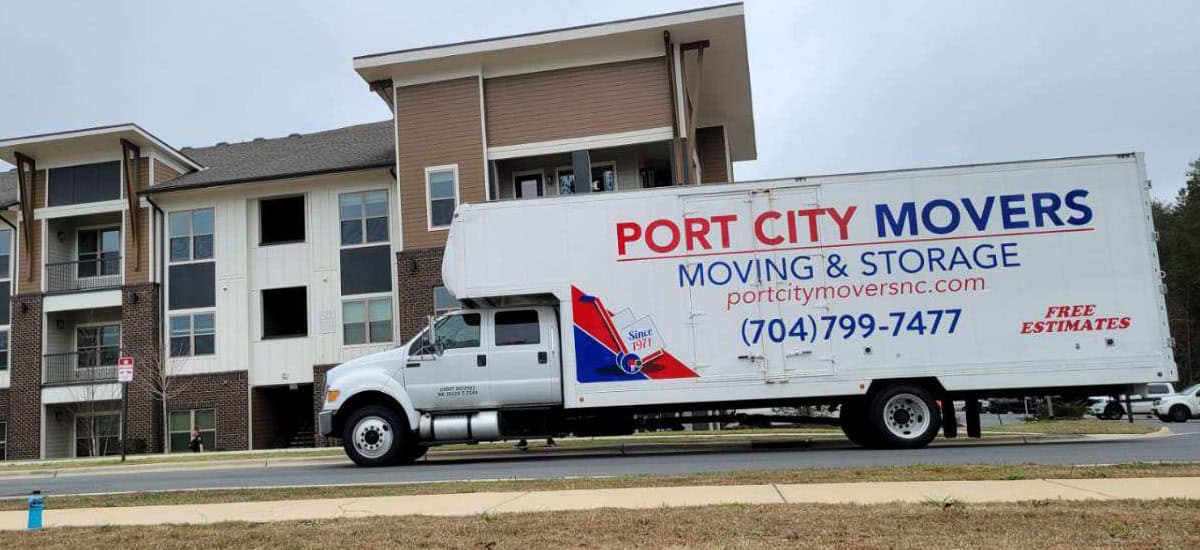 Port City Movers moving truck parked in front of apartments for moving job